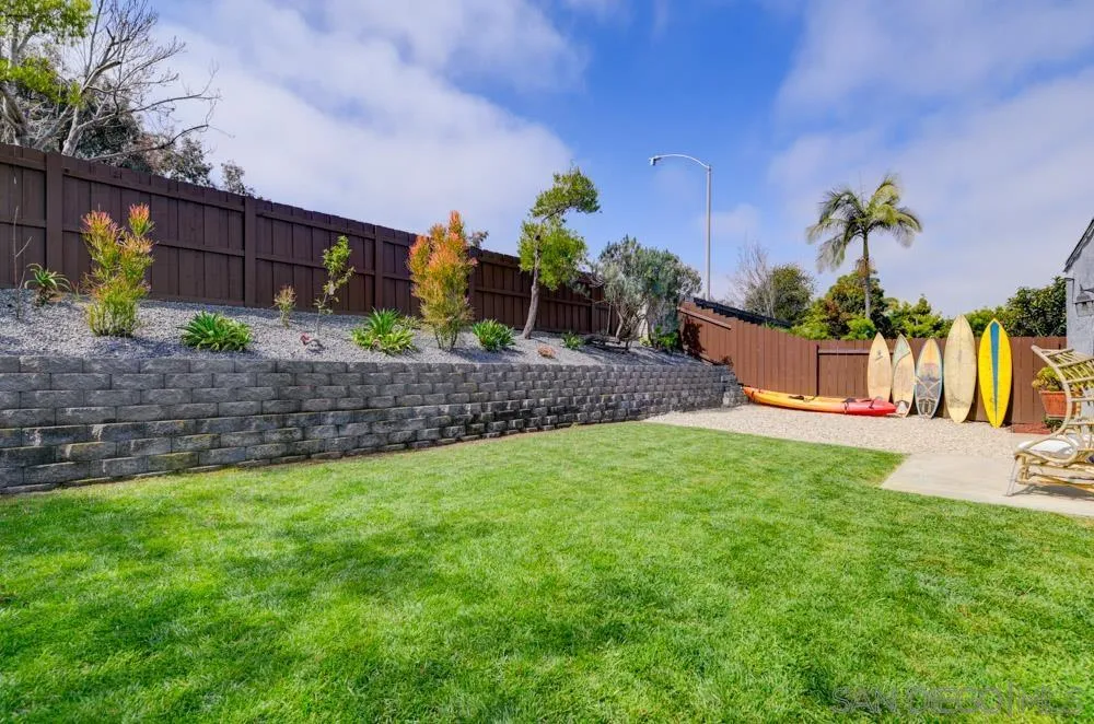1955 Village Wood Road Encinitas, CA 92024 - Photo 16 of 31 a view of a back yard with flower plants and wooden fence