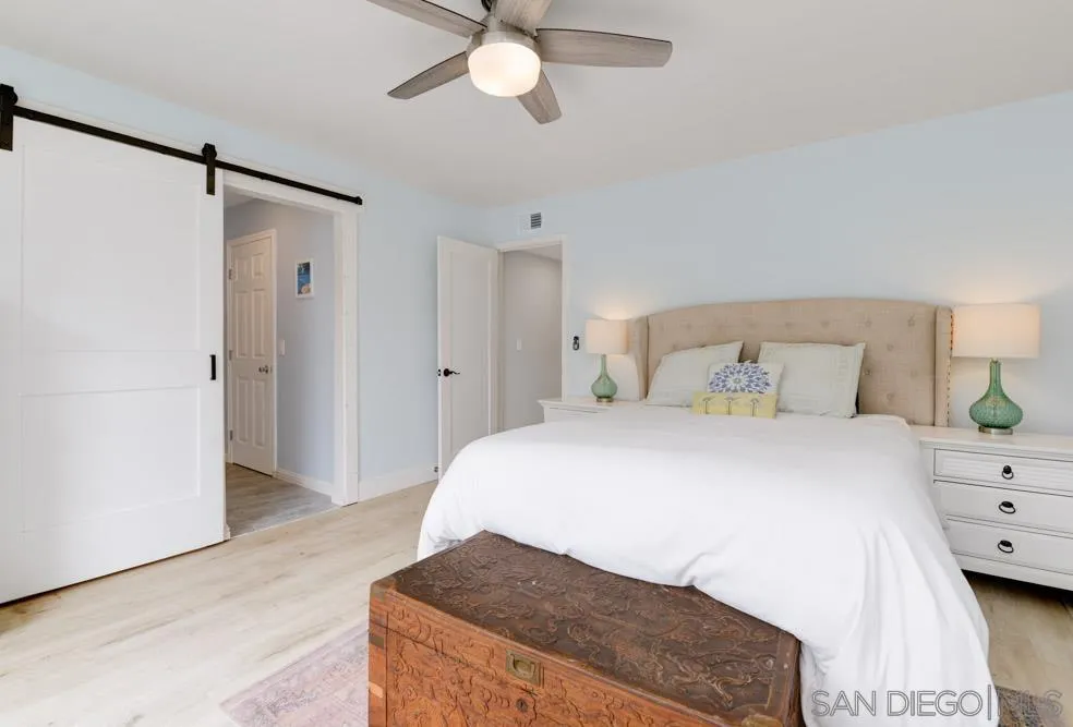 1955 Village Wood Road Encinitas, CA 92024 - Photo 23 of 31 a bedroom with a bed and a chandelier