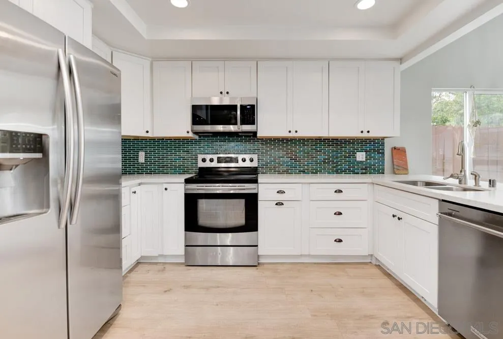 1955 Village Wood Road Encinitas, CA 92024 - Photo 9 of 31 a kitchen with stainless steel appliances a stove microwave and refrigerator