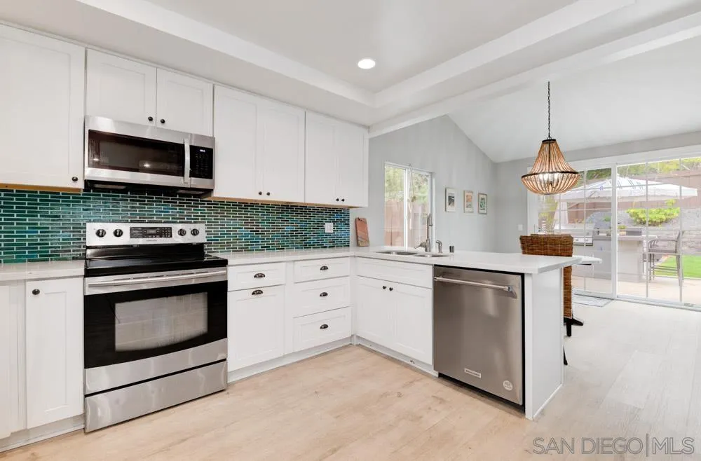 1955 Village Wood Road Encinitas, CA 92024 - Photo 10 of 31 a kitchen with stainless steel appliances granite countertop a sink a stove and a microwave