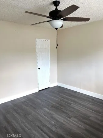 a view of an empty room and wooden floor