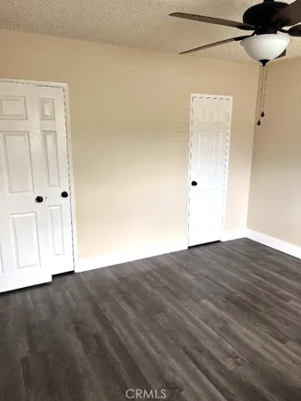 a view of a room with wooden floor and a window