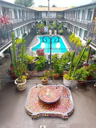 a view of a swimming pool with a patio and a garden