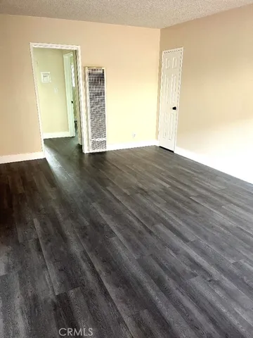a kitchen with a sink a refrigerator and wooden floor