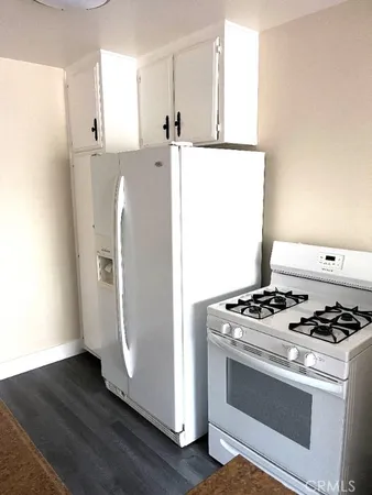 a close up of a stove with wooden floor