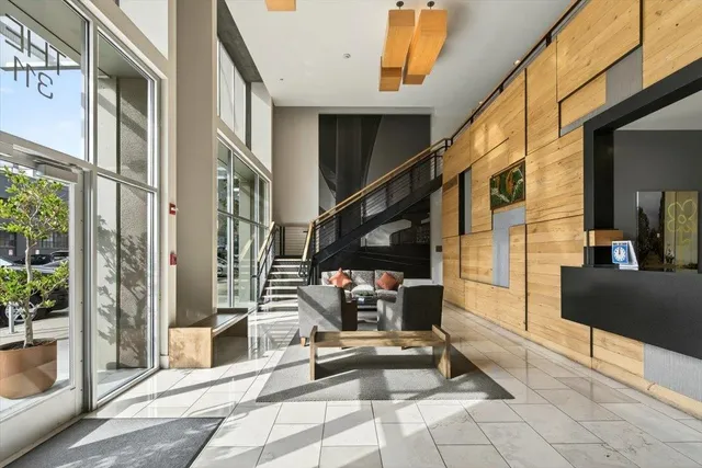 a living room with lots of furniture and stairs