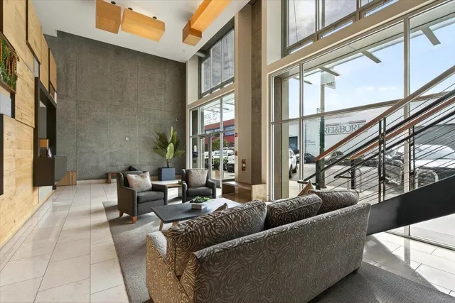 a living room with furniture and a potted plant