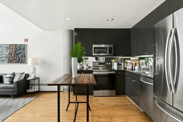 a kitchen with refrigerator and cabinets