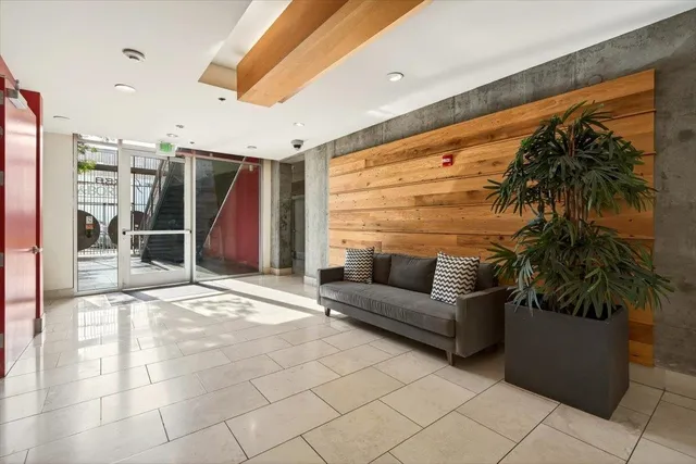 a room with furniture pool table wooden floor and windows