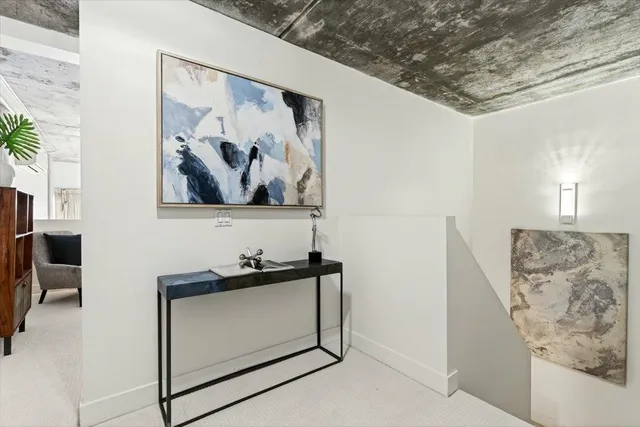 a view of a hallway with paintings on the wall