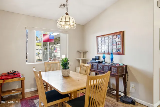 a view of a dining room with furniture and chandelier