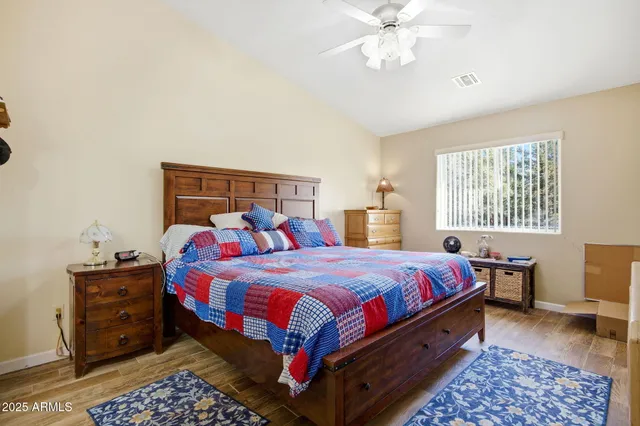 a bedroom with bed and a chandelier