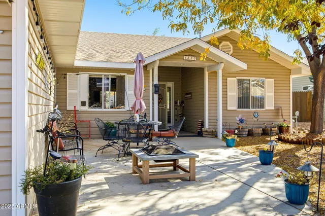 a view of a patio with couches table and chairs and potted plants