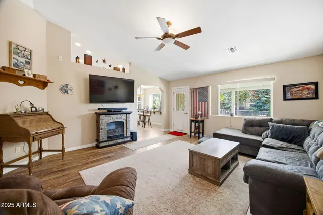 a living room with furniture a fireplace and a flat screen tv