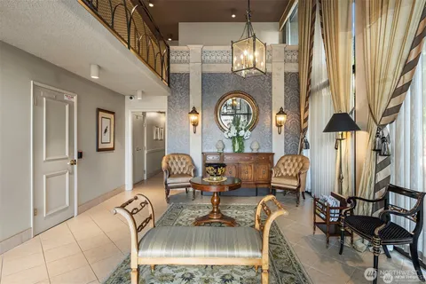 a living room with fireplace furniture and a large window