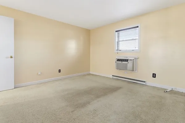 an empty room with a empty space and windows