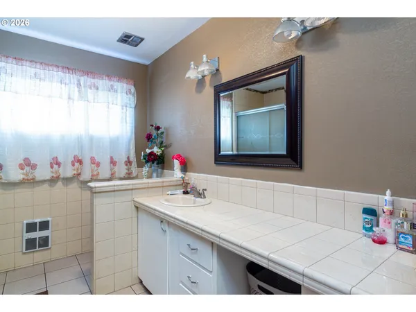 a bathroom with a sink vanity and a mirror