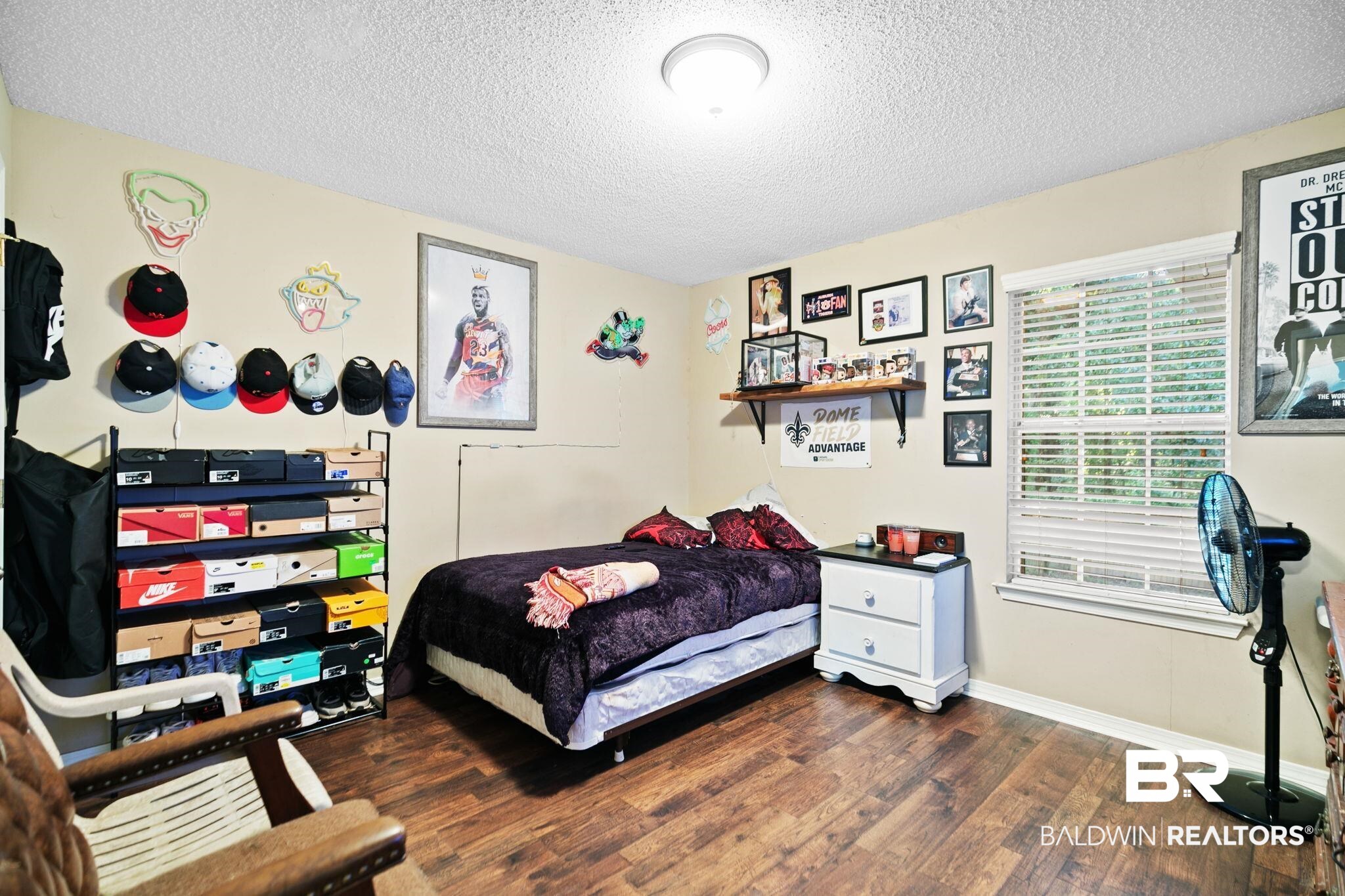 10550 Patrick Avenue Grand Bay, AL 36541 - Photo 33 of 43 Bedroom featuring hardwood / wood-style flooring and a textured ceiling