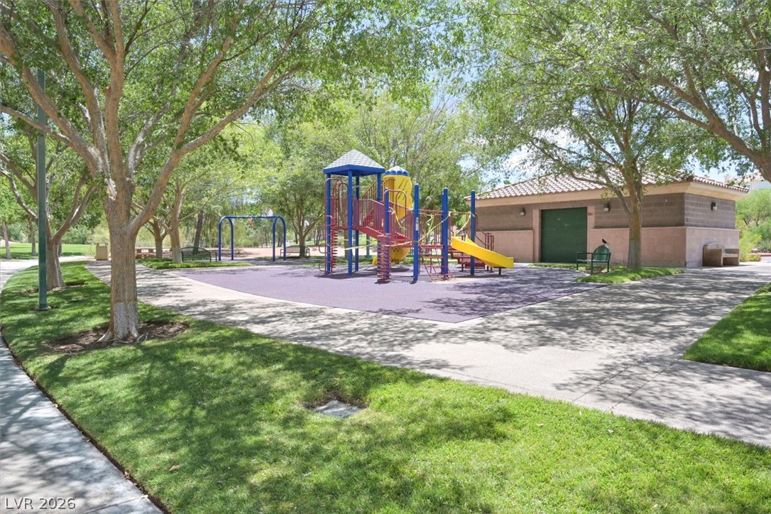 1259 Moon Vision Street Henderson, NV 89052 - Photo 52 of 53 A vibrant playground set amidst a leafy park, offering recreational enjoyment for residents.
