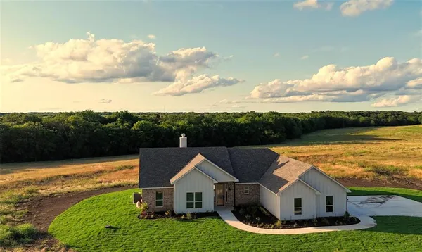 an aerial view of house with yard and swimming pool