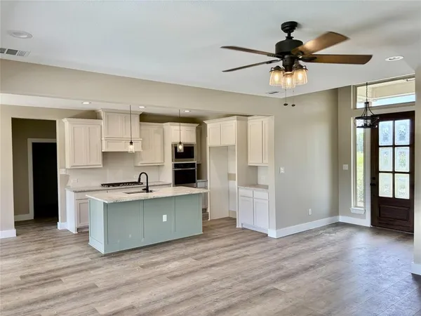 a view of kitchen with cabinets and wooden floor