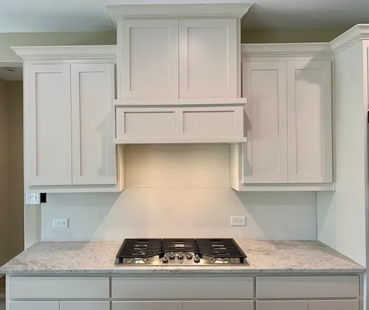 a stove top oven sitting inside of a kitchen