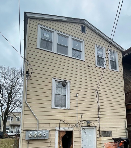 5604 South May Street Chicago, IL 60621 - Photo 2 of 9 a view of a house with a door and a tree