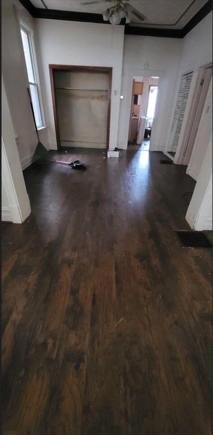 5604 South May Street Chicago, IL 60621 - Photo 9 of 9 a view of an empty room with wooden floor and a window