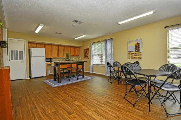 a dining room with furniture and wooden floor