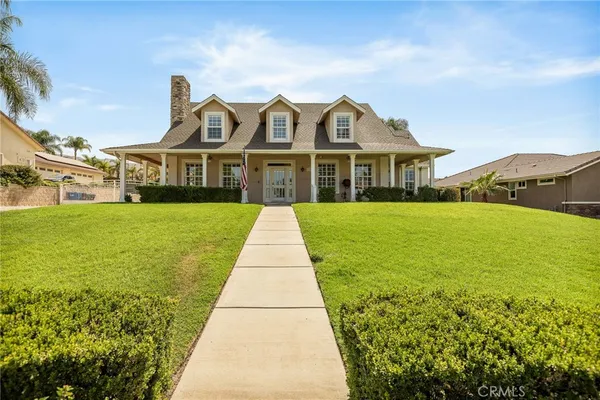 a front view of a house with yard and green space