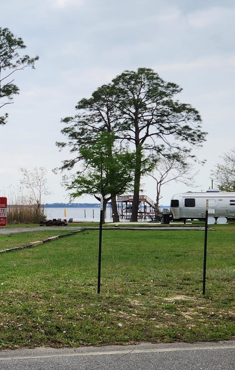 0 7th Street Lillian, AL 36549 - Photo 5 of 6 View of property's community featuring a water view and a lawn