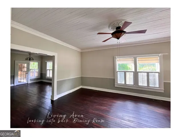 a kitchen with stainless steel appliances granite countertop a refrigerator a sink dishwasher a stove and white countertops with wooden floor