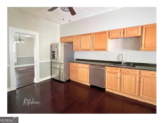 a view of hallway with stairs and wooden floor