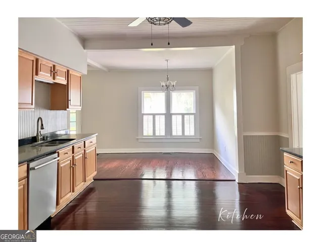 a view of a backyard with wooden fence