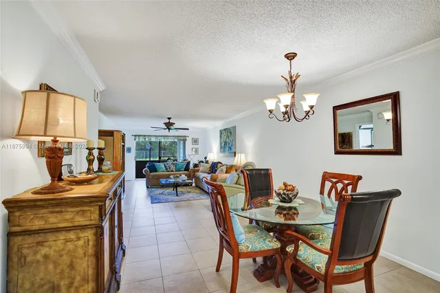 a living room with furniture ceiling fan and a rug