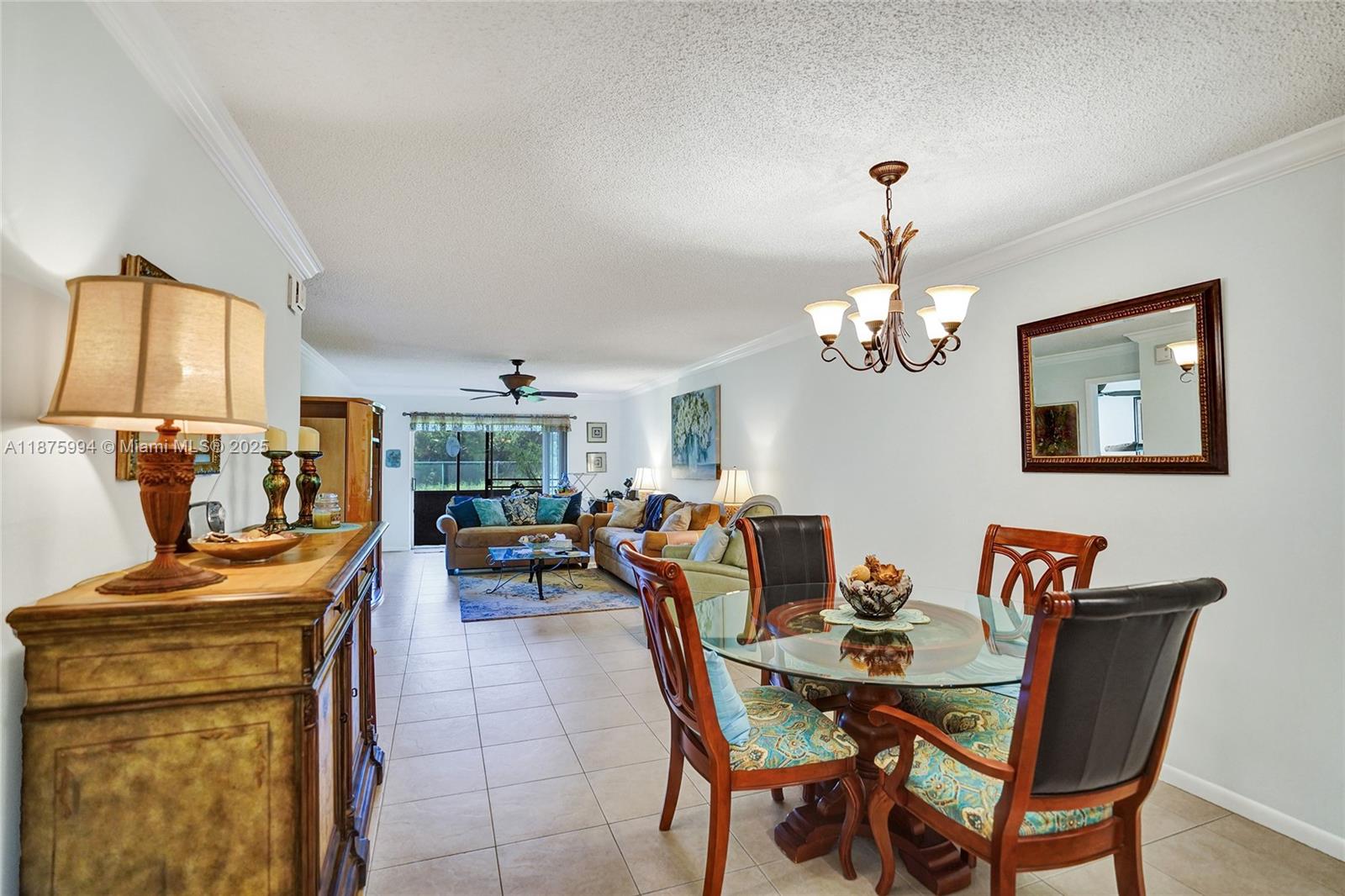 2975 Southwest 22nd Avenue, Unit 102 Delray Beach, FL 33445 - Photo 15 of 73 a view of a dining room with furniture and a chandelier