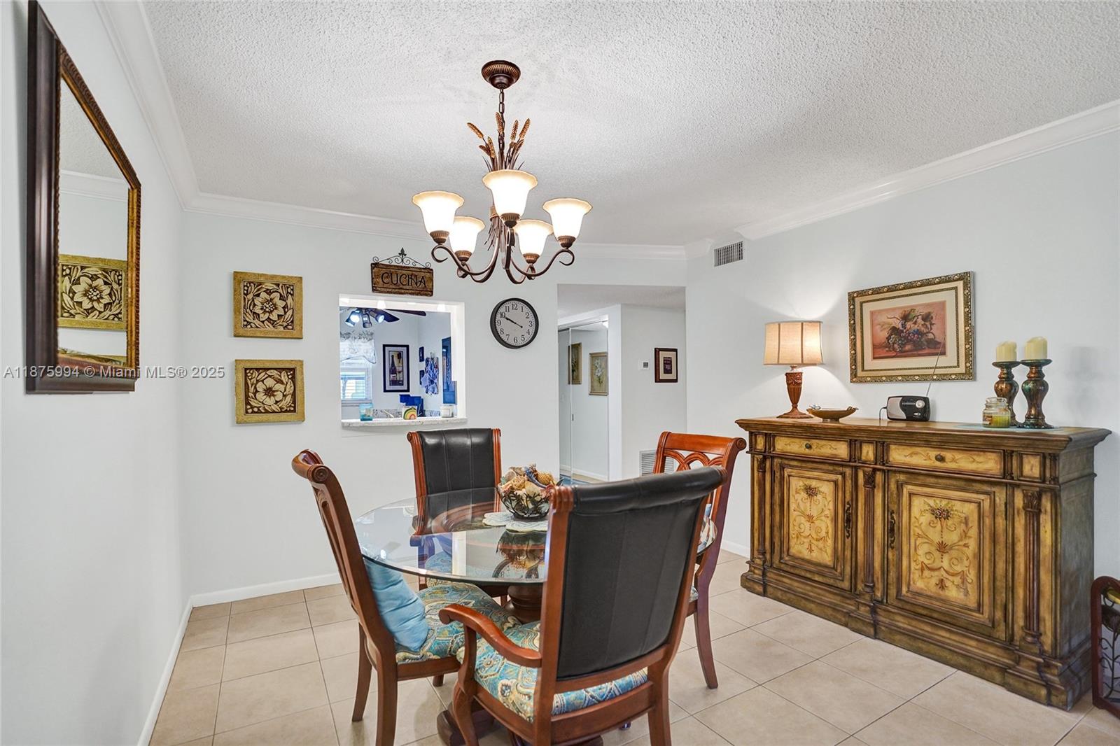2975 Southwest 22nd Avenue, Unit 102 Delray Beach, FL 33445 - Photo 17 of 73 a view of a dining room with furniture a chandelier and wooden floor