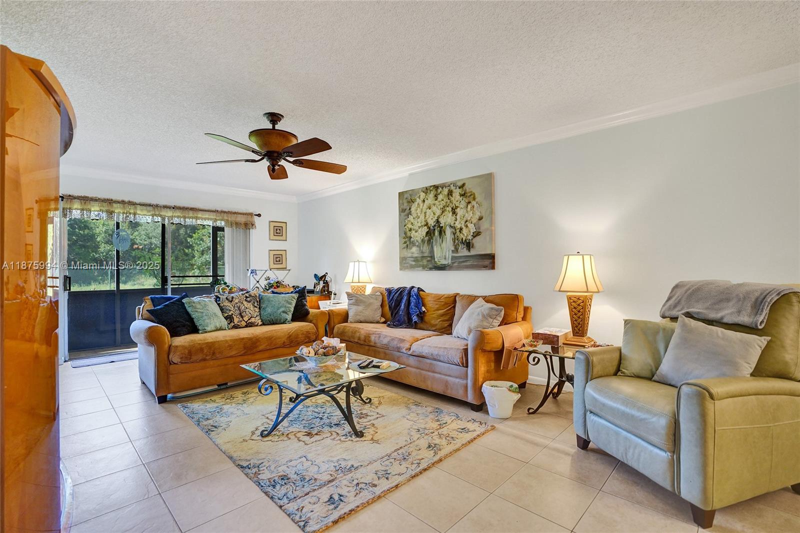 2975 Southwest 22nd Avenue, Unit 102 Delray Beach, FL 33445 - Photo 21 of 73 a living room with furniture ceiling fan and a rug