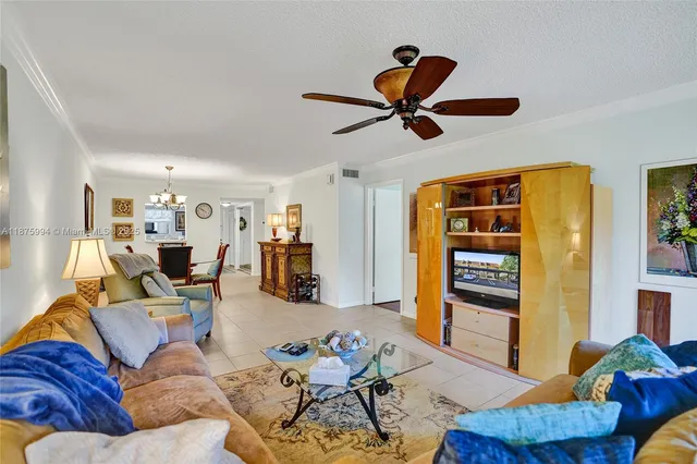 a bedroom with bed and a chandelier