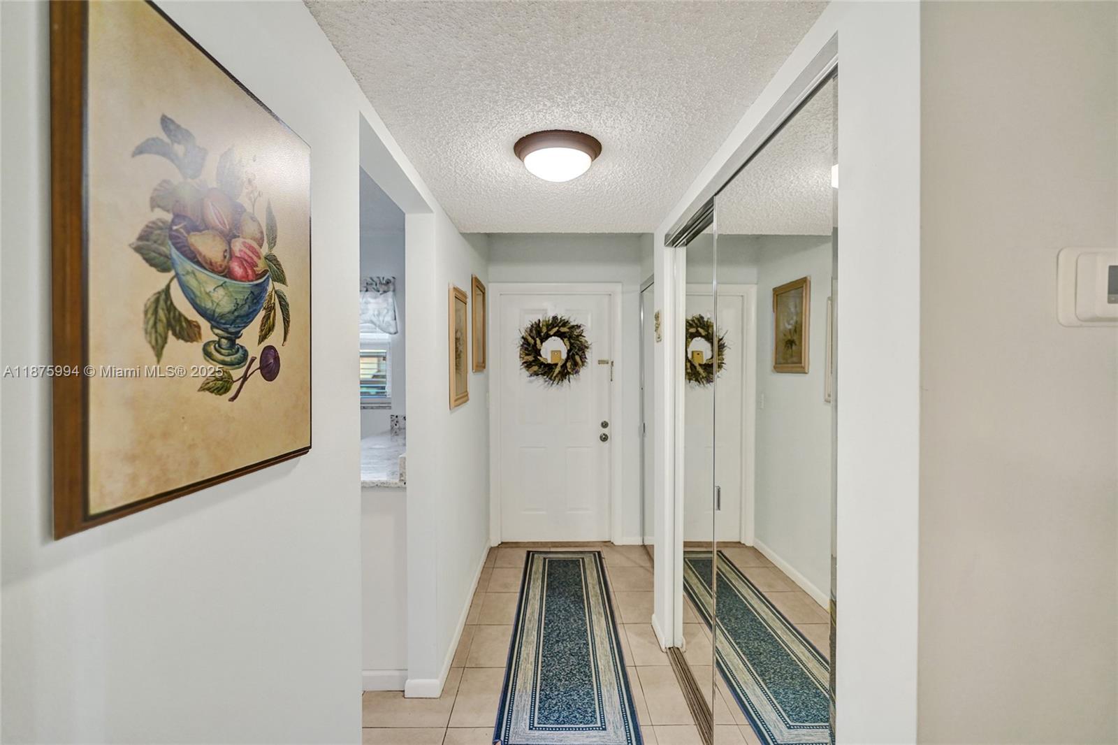 2975 Southwest 22nd Avenue, Unit 102 Delray Beach, FL 33445 - Photo 28 of 73 a view of a hallway with wooden floor and closet