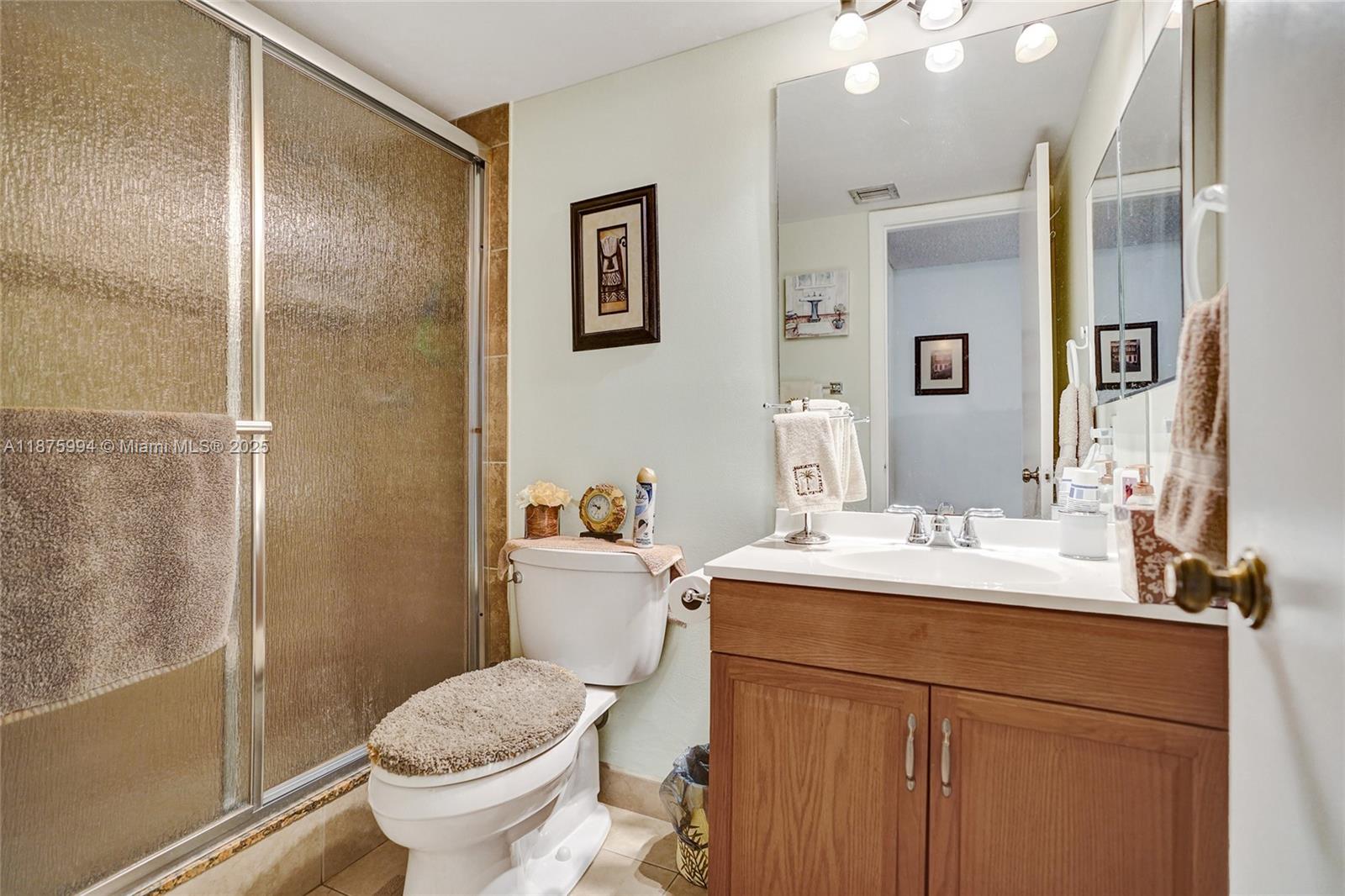 2975 Southwest 22nd Avenue, Unit 102 Delray Beach, FL 33445 - Photo 29 of 73 a bathroom with a sink toilet and shower