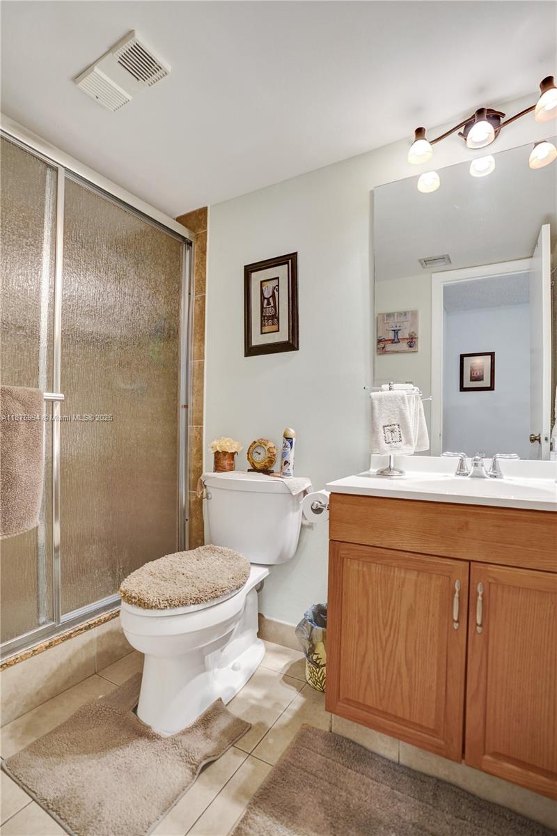 2975 Southwest 22nd Avenue, Unit 102 Delray Beach, FL 33445 - Photo 30 of 73 a bathroom with a sink toilet and shower