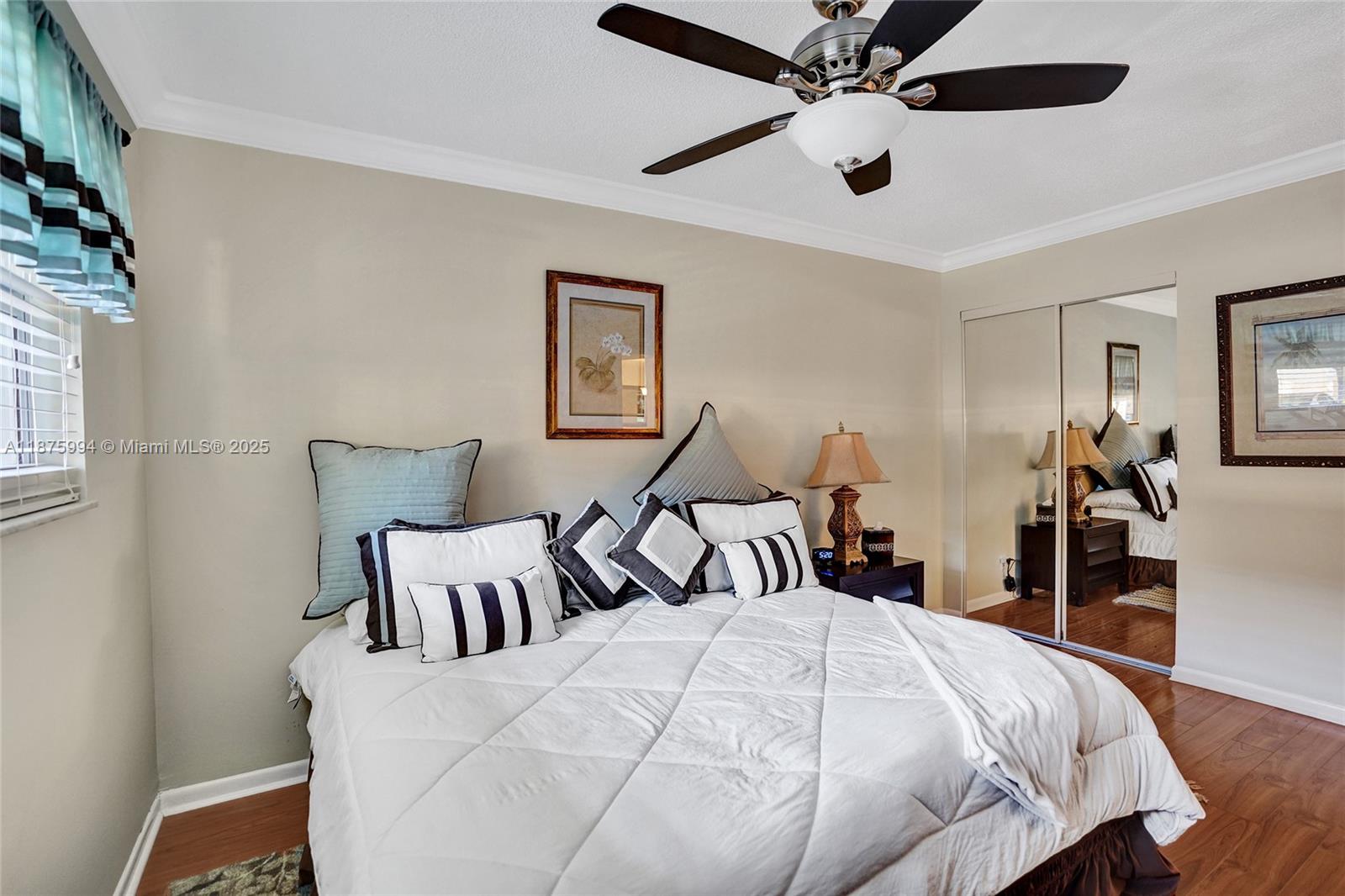 2975 Southwest 22nd Avenue, Unit 102 Delray Beach, FL 33445 - Photo 34 of 73 a bedroom with bed and a chandelier