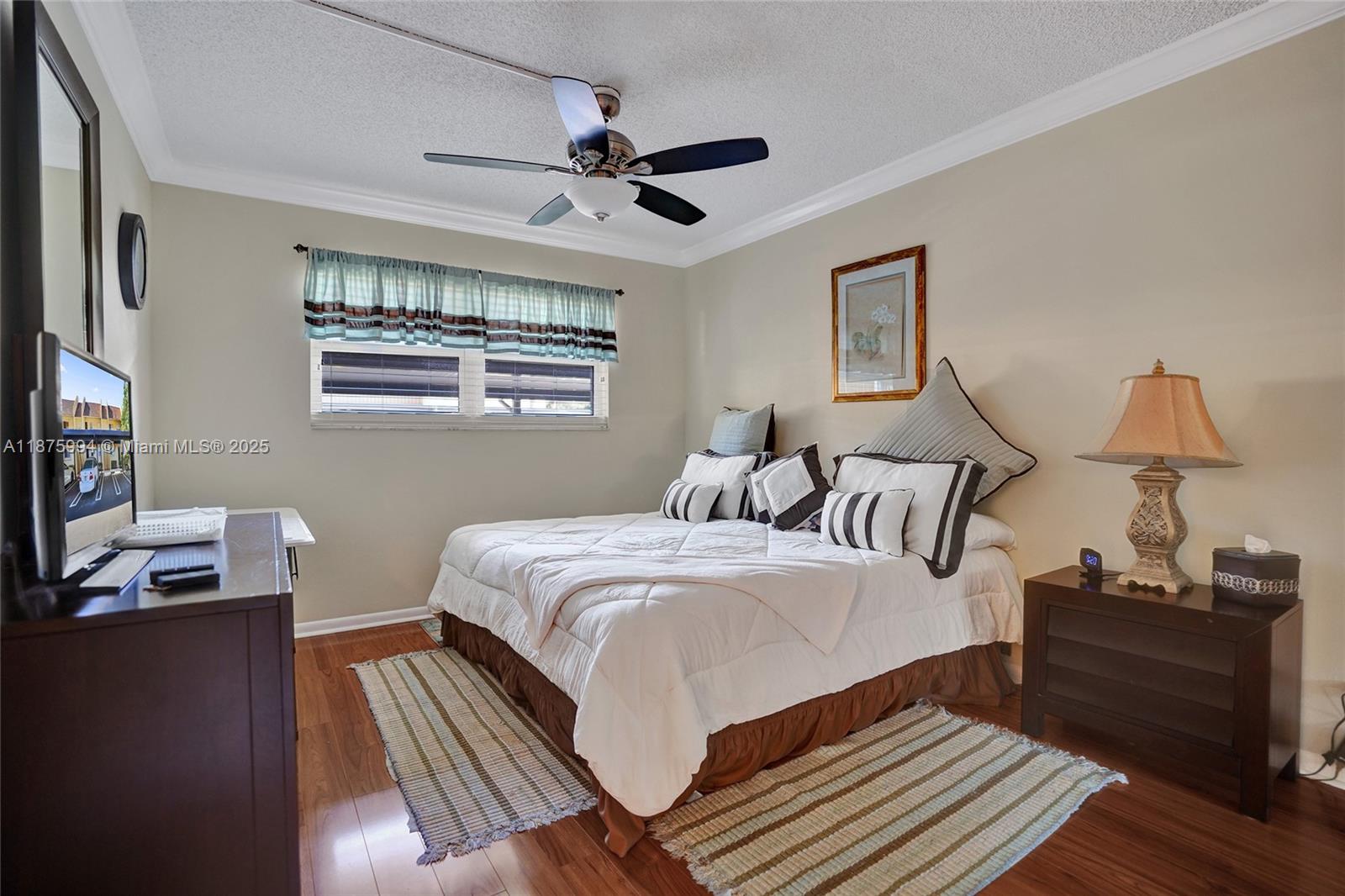 2975 Southwest 22nd Avenue, Unit 102 Delray Beach, FL 33445 - Photo 35 of 73 a bedroom with a bed and a window
