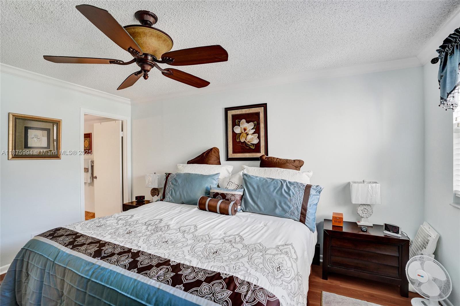 2975 Southwest 22nd Avenue, Unit 102 Delray Beach, FL 33445 - Photo 39 of 73 a bedroom with a bed and wooden floor