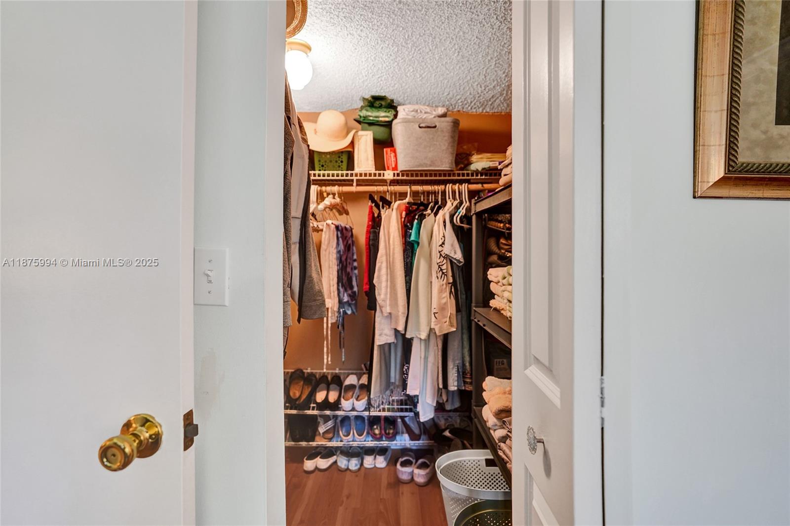 2975 Southwest 22nd Avenue, Unit 102 Delray Beach, FL 33445 - Photo 41 of 73 a view of walk in closet with clothes and shoes