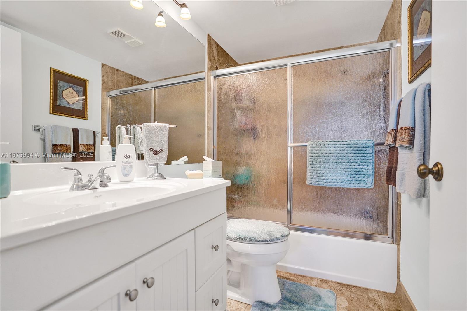 2975 Southwest 22nd Avenue, Unit 102 Delray Beach, FL 33445 - Photo 44 of 73 a bathroom with a sink toilet and shower