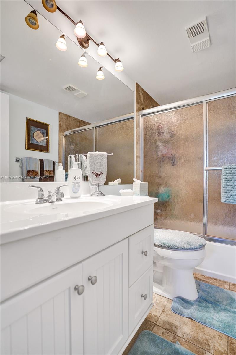 2975 Southwest 22nd Avenue, Unit 102 Delray Beach, FL 33445 - Photo 46 of 73 a bathroom with a sink toilet and shower