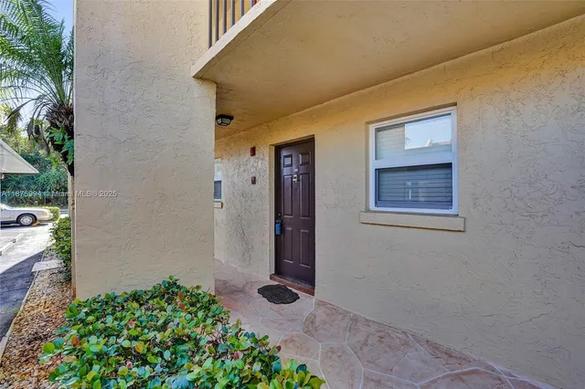 a kitchen with stainless steel appliances granite countertop a refrigerator a stove a sink and white cabinets