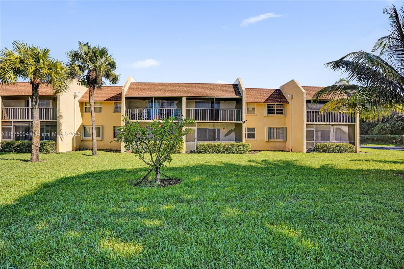 2975 Southwest 22nd Avenue, Unit 102 Delray Beach, FL 33445 - Photo 52 of 73 a house with garden in front of it